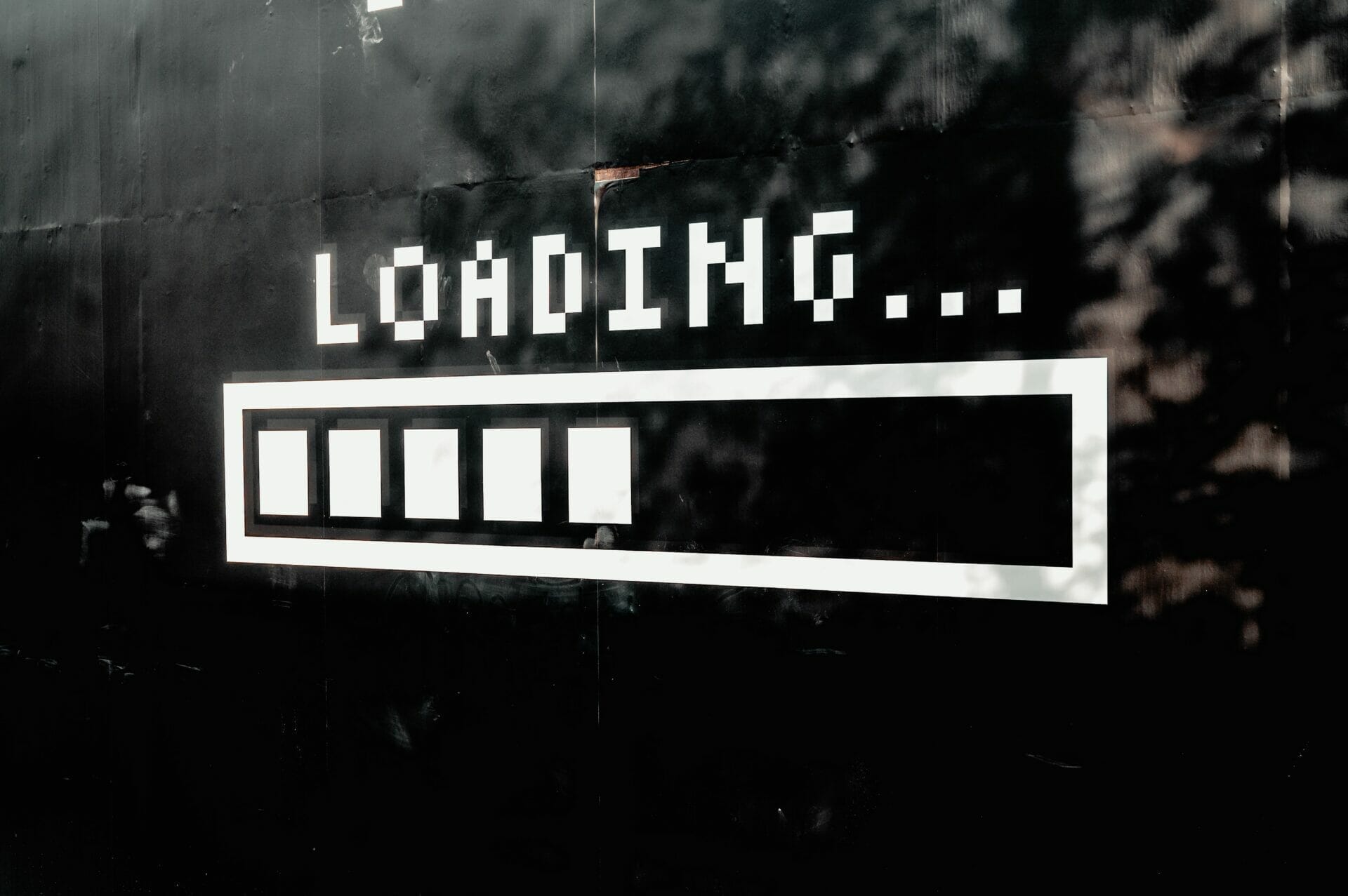 A black background with the word "Loading..." and a progress bar partially filled, depicted in a pixelated font style resembling early video games.