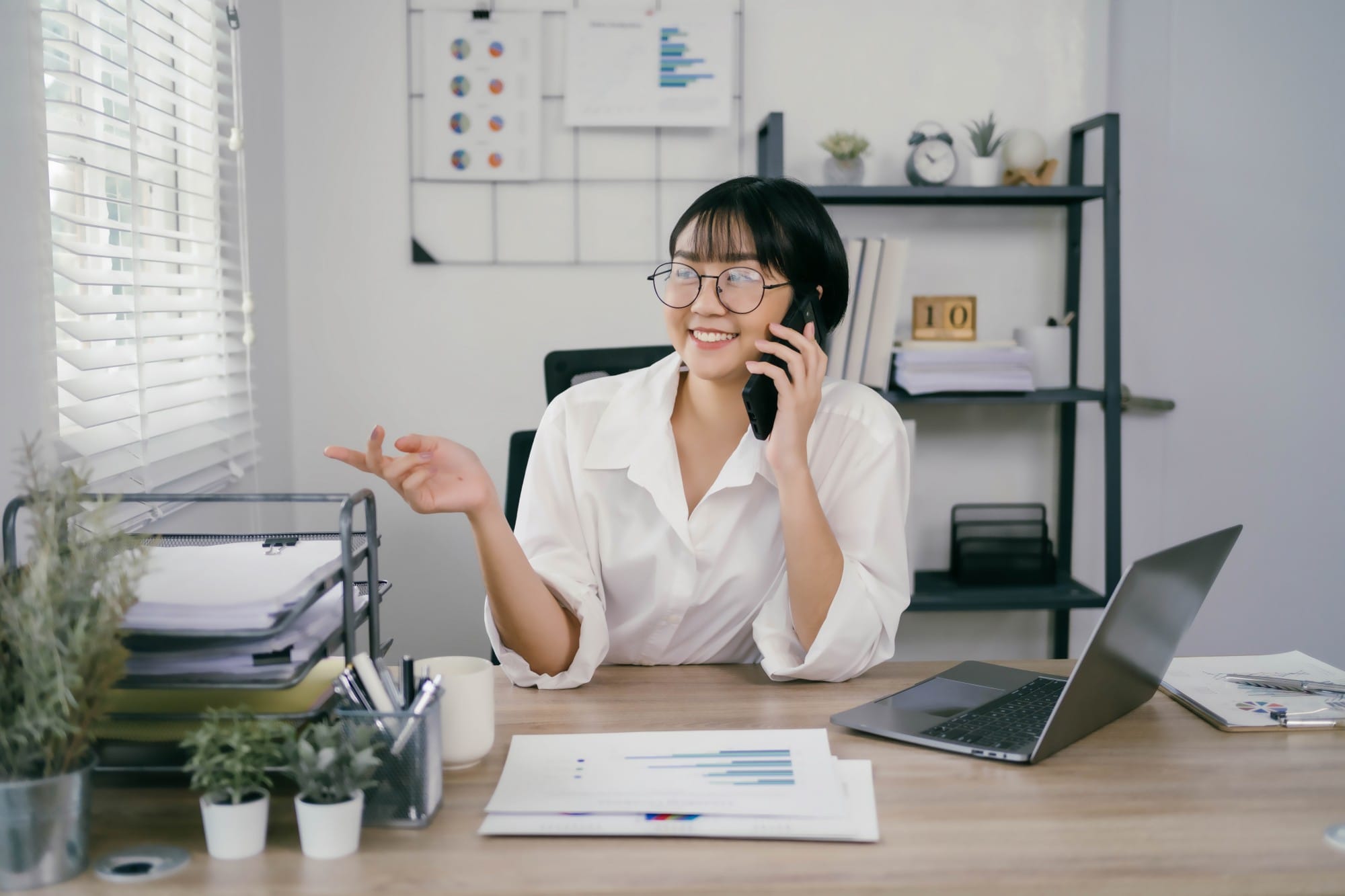 A woman is talking on her cell phone in a cubicle 2025 01 10 13 32 12 utc